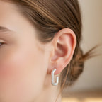Silver hoop earrings on a white background